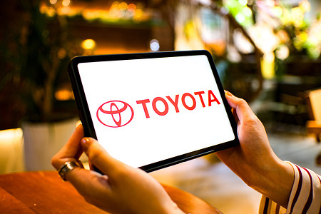 In this photo illustration, the Toyota Motor Corporation logo is seen displayed on a tablet screen.