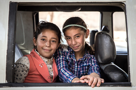 Two refugee children sit in a jeep at a distribution center in the Jordanian mountains.
There are about 1.4 million Syrian refugees in Jordan and only 20 percent are living in the refugee camps with the majority interspersed throughout the state, environmental resources are scarce for both Syrians and their Jordanian hosts. This increases pressure on Jordan’s infrastructure, specifically the provision of water supplies, sanitation facilities, housing, and energy.