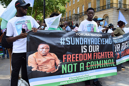 Demonstrators hold a pro-Sunday Igboho banner during the Yoruba Nation protest.Nigeria's Yoruba Nation supporters gathered outside Downing Street to demand the release of activist Sunday Adeyemo, also known as Sunday Igboho, who was recently arrested in Benin.