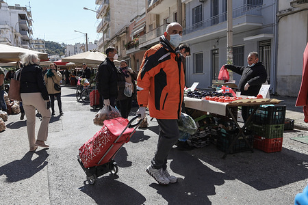 A man wearing a face mask as a preventive measure, shopping at the green market during the corona virus threat.
Greek authorities requested commercial stores to close and people to stay at home to prevent the spread of coronavirus.