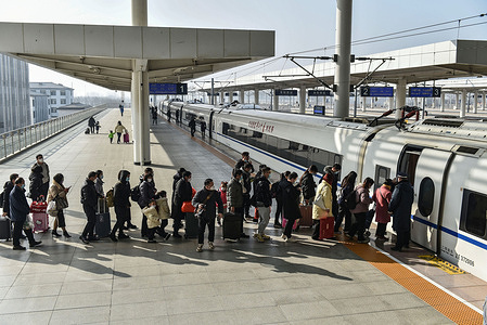 Passengers wearing masks wait to board a train at a train station Around 6.3 million passenger trips are expected to be made across China on Saturday, the first day of this year's Spring Festival travel rush, the national railway operator China State Railway Group said. China optimized its epidemic control management recently, and epidemic measures for travel were also optimized last month. Travelers no longer need negative nucleic acid test results or health codes, are not required to undergo nucleic acid testing or health inspection upon arrival, and will not have their temperatures checked. About 2.1 billion passenger trips are expected to be made during the period, a year-on-year increase of 99.5 percent, Vice-Minister of Transport Xu Chengguang said at a news conference. This year's travel rush will start on Saturday and end on Feb 15. The Spring Festival will fall on Jan 22.