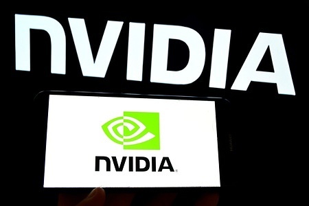 In this photo illustration, the Nvidia logo a company specializing in artificial intelligence is displayed on a smartphone and in the background.
