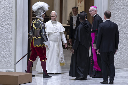 Pope Leo XIV leaves at the end of the swearing-in ceremony of 28 new recruits to the Swiss Guard in the Paul VI Hall in the Vatican.