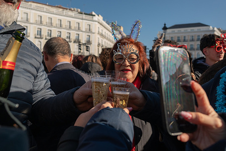 People celebrate and drink 12 grapes during the Preuvas as a rehearsal of the tradition of the 12 bells of New Year's Eve at Puerta del Sol.