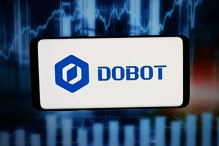 In this photo illustration, the logo of robotics company Shenzhen Dobot Corp Ltd. is displayed on a smartphone in front of abstract background on computer screen.