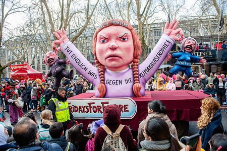 Figure of activist Greta Thunberg is seen in one of the the politically themed floats of satirist Jacques Tilly during the carnival.
In Düsseldorf, the calendar of Carnival events features no fewer than 300 Carnival shows, balls, anniversaries, receptions and costume parties. The motto this season is ‘Gemeinsam Jeck’ (Together Carnival). The celebrations culminate in the Rose Monday Parade. More than 30 music ensembles and 5,000 participants join the procession through the city. Elaborately built and decorated floats address cultural and political issues and can be satirical, hilarious and even controversial. The politically themed floats of satirist Jacques Tilly are famous in the world over.