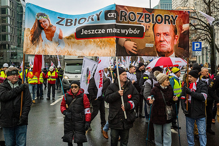 Protesters carry a banner that says, in Polish, "harvest or partitions. Do you still have a choice?" during the rally. Energy workers, including coal miners from the Solidarity union, marched through Warsaw from the Polish Energy Group headquarters to the Ministry of State Assets. The demonstration opposed government plans to close coal-powered stations in Silesia. Organizers pledged to resist the closures while advocating for more affordable electricity for Polish households.