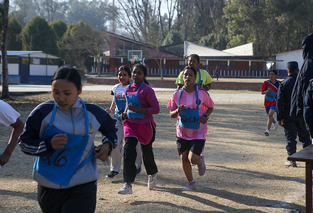 Nepalese applicants take part in a physical fitness test during the selection of temporary police officers for the upcoming general elections.