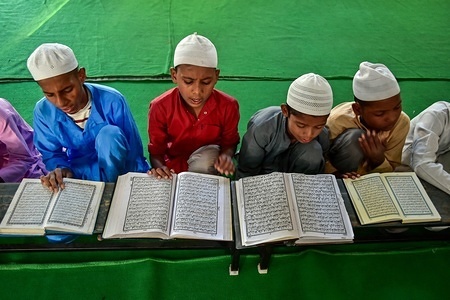 Indian children are seen reciting the holy Quran in a mosque during the first day of the holy fasting month of Ramadan in Patiala district of Punjab.
Muslims throughout the world are marking the month of Ramadan, the holiest month in the Islamic calendar in which devotees fast from dawn till dusk.