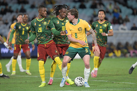 Connor Metcalfe (R) of Australia men football team, Christian Kofane (back) and Ryan Fosso (back) of Cameroon men football team seen in action during the FIFA Series 2026 match between Australia and Cameroon held at the Accor Stadium. Final score; Australia 1:0 Cameroon.