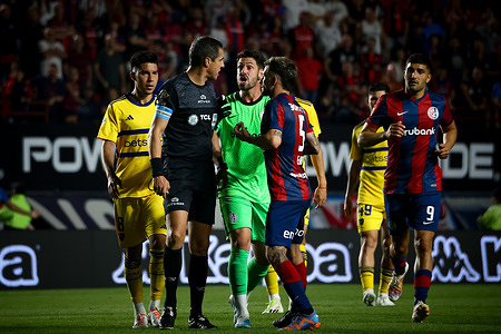Guillermo Fernandez of Boca Juniors (L), referee Pablo Echavarria (C), Augusto Batalla of San Lorenzo (CR) and Jalil Elias of San Lorenzo (CRR) argue about the annulment of what would have been the winning goal at the request of the VAR during the match during the match between San Lorenzo de Almagro and Boja Juniors as part of Copa de la Liga - Fecha 12- Zona B at Estadio Pedro Bidegain. Final Score: San Lorenzo 1 : 1 Boca Juniors.