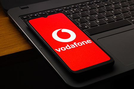 In this photo illustration, the Vodafone Group Plc logo is seen displayed on a smartphone screen.