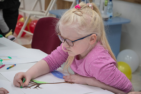 A girl seen drawing during an art therapy at a hospital. Children who have suffered as a result of the war and are undergoing treatment and rehabilitation in Lviv, attend the psychosocial art therapy event "Unbreakable Hearts of Ukraine" on the occasion of International Children's Day at St. Nicholas Children's Hospital. The event program included an educational block where children were told about their rights, art therapy with coloring shoppers and drawing with pencils, and festive treats. St. Nicholas Hospital is currently treating several hundred children, including internally displaced children, children with injuries and developmental disabilities caused by the war. "The event draws attention to the violation of children's rights during the war and Russia's war crimes against children, and also emphasizes the need for constant psychosocial and social support for young patients," the organizers of the event note.