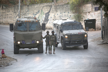 Israeli soldiers closed the main road in the village of Salem, east of Nablus in the West Bank, during the military operation, which included raids and searches of Palestinian homes, resulting in the arrest of two brothers and a third person, following a heavy deployment of forces throughout the village.