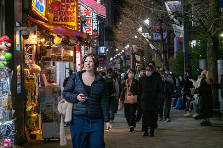 Pedestrians walk along a brightly lit street lined with anime, video game, and retail shops in the Akihabara district of Tokyo, Japan. The area is a major hub for otaku culture, electronics, and entertainment. Akihabara, often called Tokyo’s Electric Town, is a major shopping district known for electronics, anime, manga, and gaming culture. Bright signage, specialty shops, and themed cafés make it a hub for tech enthusiasts and fans of Japanese pop culture.