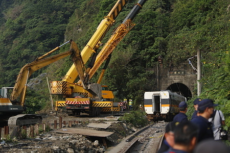 A damaged train carriage is lifted and removed from a track for clearance after derailing in a tunnel.
The government reports the crash is believed to have been caused by a construction vehicle that fell from the highway on to the tracks. The train was derailed after colliding with the vehicle, and hit the wall of the tunnel, causing 51 deaths and dozens injured making it the most catastrophic train accident in the past 20years.