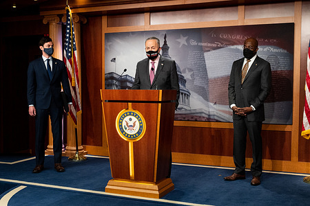 Senate Majority Leader, Chuck Schumer (D-NY) speaking, with U.S. Senator Jon Ossoff (D-GA) and U.S. Senator Raphael Warnock (D-GA) standing next to him, about the COVID-19 relief legislation being worked on in the Senate.