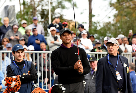 Tiger Woods prepares to tee off on the first hole of the Pro-Am at the PNC Championship golf tournament at the Ritz-Carlton Golf Club. Woods is playing in the tournament with his son, Charlie Woods.