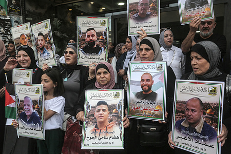 Mothers of Palestinian prisoners hold pictures of their detained sons during a solidarity rally. Palestinians staged a protest to demand a prisoner exchange agreement with the Israeli government and Hamas.