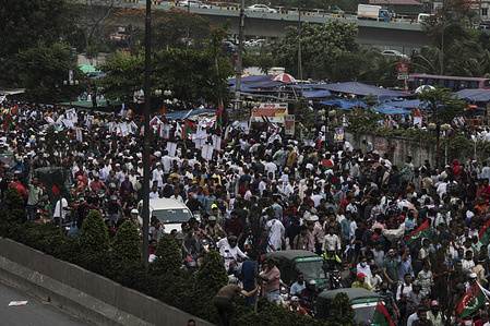 Bangladesh Nationalist Party (BNP) leaders and activists match during the welcome event. Chairperson Khaleda Zia's motorcade en route from Dhaka Hazrat Shahjalal Interational Airport to her Gulshan home. After four months of receiving medical treatment in London, BNP Chairperson Khaleda Zia returned home to a grand welcome. BNP leaders and activists crowded Dhaka's Airport Road to greet her causing traffic congestion in several areas.