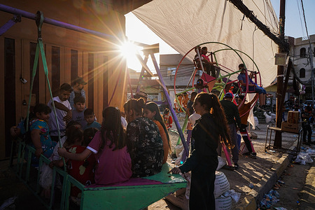 Iraqi children play at a mobile amusement park as they celebrate Eid al-Adha in the old city of Mosul northern Iraq.