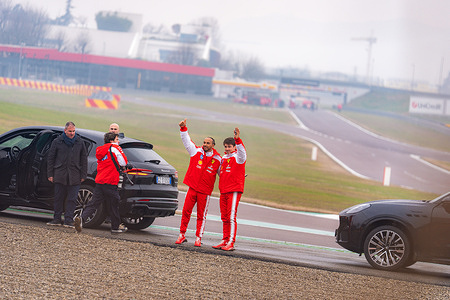 Scuderia Ferrari HP F1 Team's drivers Lewis Hamilton and Charles Leclerc wave at the fans after the shakedown at the circuit of Fiorano.