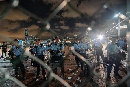 Police officers seen guarding the plot of land in the Central Waterfront which to be transferred to the Chinese People's Army. 
Hundreds of protesters rally against government transferring a plot of land on the Central Waterfront to the Chinese People's Liberation Army (PLA) as a military dock. Pro-democracy demonstrators in Hong Kong have organized rallies over the past weeks, calling for the withdrawal of a controversial extradition bill, the resignation of the territory's chief executive Carrie Lam, an investigation into police brutality, and drop riot charges against peaceful protesters.