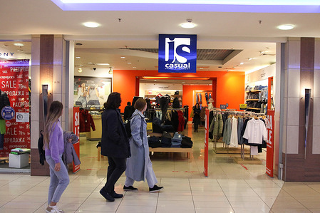 Visitors look at clothes at the casual jeans symphony store in the Grand Canyon Shopping and Entertainment Complex.