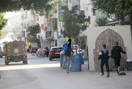 Palestinians threw stones at military vehicles during a security operation in Balata refugee camp, east of Nablus. Israeli forces entered the market and closed the camp's entrance. Soldiers also raided shops, arrested residents, and interrogated them about the security situation in Balata camp.