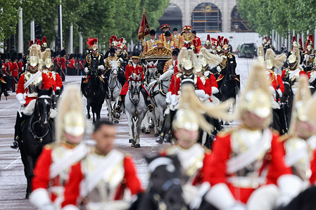 Grenadier Guards seen on horses as King Charles III and Queen Camilla travel along The Mall towards Buckingham Palace in the Diamond Jubilee State Coach after attending the State Opening of Parliament.