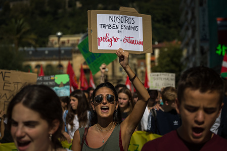 A student holds a placard while chanting slogans during the march.
Thousands of students demonstrate on the streets of San Sebastian, Spain, against climate change on the day of the World Climate Strike.
