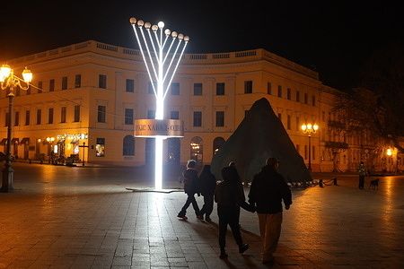 People walk by a giant Hanukkah erected on Primorsky Boulevard in Odessa, near the Duke monument. Hanukkah is a Jewish holiday that lasts eight days, from December 14 to 22 in 2025.
The holiday commemorates the restoration of the Second Temple in Jerusalem and the miracle of the Menorah.
Hanukkah symbolizes the victory of light over darkness, faith over unbelief, and the importance of devotion to tradition.