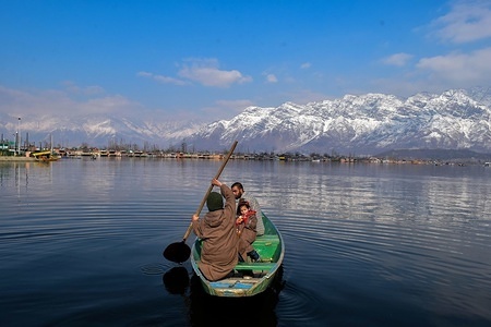 A young boatman seen ferrying passengers on a sunny winter day in Srinagar, Indian administered Kashmir. The valley witnessed a sunny day despite cold conditions in Kashmir valley bringing down temperatures below the freezing point at night. The minimum temperature was minus 3.5 degrees Celsius in Srinagar. The weather man has forecast heavy rain and snowfall on January 30 and 31.