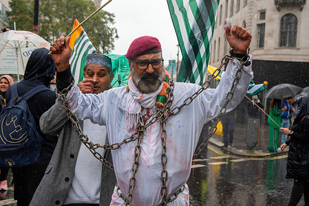 A protester seen holding up his hands to show his chains while marching to the Indian High Commission during the demonstration. Kashmir diaspora (migrants) in London marched to the Indian High Commission demanding the release of all political prisoners including Yasin Malik. Yasin Malik is a separatist leader, former militant, and the Chairman of the Jammu Kashmir Liberation Front. He wants the separation of Kashmir from both India and Pakistan. He was found guilty of criminal conspiracy and waging war against the state and was sentenced to life imprisonment in India.