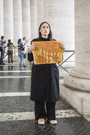 Yona Tukuser stands with a placard reading “Hope for Peace,” a personal vigil that began around April 25, 2025, and will continue until the election of the new Pope, which started on May 7. She describes her presence as a form of prayer, honoring the peace-centered legacy of the late Pope Francis. Tukuser shared her fear following the Pope’s passing, saying, “It feels like we lost the strongest voice of peace.”