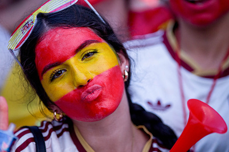 A fan is seen with her face painted in the Spanish flag colours during the semi-final match of the 2026 FIFA World Cup, football match between Spain and France. Spanish fans celebrate in front of a giant screen on the esplanade of the Puente del Rey, Río Park in Madrid, where Spain defeats France in the semi-final match of the 2026 FIFA World Cup.
