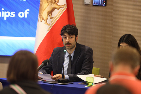 Soroush Aboutalebi, a political science graduate and president of the youth association in Brussels, speaks into a microphone at the head table. Representatives of Iranian youth communities from across Europe gathered for a press conference in Brussels titled “Iran: Wave of Political Executions – The EU’s Responsibility & Policy Options.” During the event, human rights activists and youth association leaders presented a joint statement signed by over 1,000 young Iranians calling on the European Union to halt political executions in Iran, recognize the Iranian people's right to democratic change, and support the upcoming international demonstration in Paris on June 20.