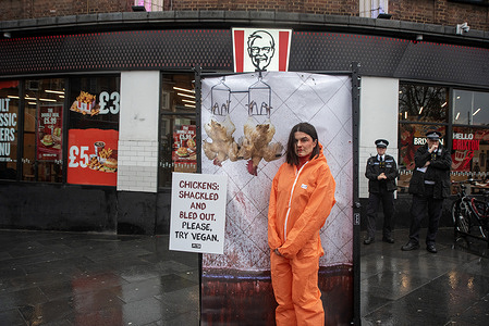 An activist poses for a photo after the action outside the KFC restaurant. PETA (People for the Ethical Treatment of Animals) activists gathered for an eye-popping action and pro-vegan display outside the KFC fast food restaurant in Brixton, London. The activists try to deliver the message by showing how it happens and save chickens from slaughtering. They are prompting people to try vegan lifestyle instead.