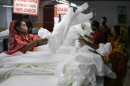 Workers manufacture protective suits at a garment factory during the lockdown imposed by the government amid concerns about the spread of Coronavirus pandemic in Dhaka.Bangladesh has confirmed 51 cases, with 5 deaths due to corona virus (COVID-19), According to the IEDCR officials.