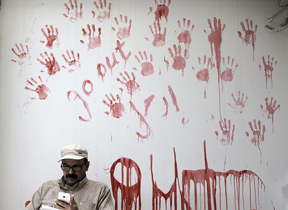 United Nations Relief and Works Agency for Palestine Refugees (UNRWA) employee seen sitting from of a painted wall as he take part in a protest against job cuts announced by the agency's headquarters in Gaza City.
UNRWA announced today that it was cutting more than 250 jobs in the Palestinian territories after the United States held back hundreds of millions in aid.