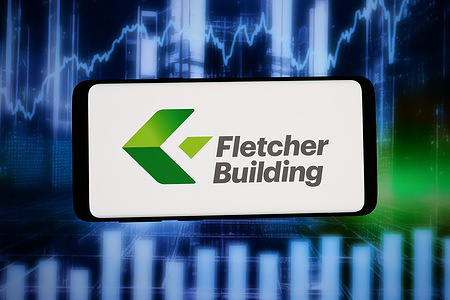 In this photo illustration, the logo of construction company Fletcher Building Ltd. is displayed on a smartphone in front of abstract background on computer screen.