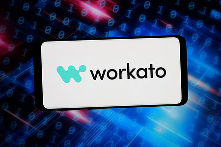 In this photo illustration, the logo of US automation software company Workato is seen displayed on a smartphone in front of an abstract background on a computer screen.