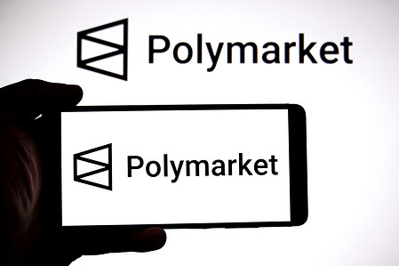 In this photo illustration, a Polymarket logo is seen displayed on a smartphone and in the background.