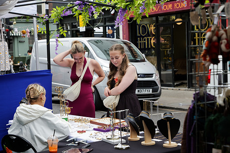 Shoppers look at items on sale at the stall, on the Portobello Road Market in west London’s Notting Hill. The Portobello Road Market is famous for its antiques and market which comes alive on Saturdays, with over 1,500 stalls. Alongside the antiques, you’ll find a vibrant mix of vintage clothing, jewelry, street food, and local artwork.