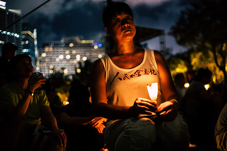A woman seen holding candles during the memorial vigil of the 1989 Tiananmen massacre.
For the 28th year in succession, tens of thousands people had gathered in Hong Kong's Victoria Park on the evening of June 4 in commemoration of the anniversary of the 1989 Tiananmen Square massacre in Beijing.
