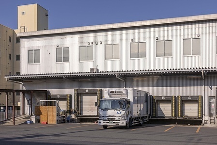 An empty loading area of a warehouse inside an industrial zone in Yokohama. "As of mid-January 2026, Japan's economy continues its gradual normalization after years of stagnation, exhibiting modest but resilient growth amid persistent inflationary pressures and a notably weak yen. Real GDP growth forecasts for 2026 generally range from 0.7% to 1.0% (with estimates from the IMF at 0.7%, Goldman Sachs at 0.8%, Vanguard at 1%, and others around 0.8–0.9%), supported by firm private consumption bolstered by ongoing wage gains, permanent income tax cuts, government stimulus measures, and steady corporate capital investment, even as external headwinds like U.S. tariffs have so far proven limited in impact."