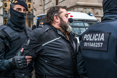 An activist with a black clown nose is evicted by the Catalan police. Convened by the Committee of Defense of the Republic (CDR) hundreds of activists have blocked for two hours the doors of the Superior Court of Justice of Catalonia in Barcelona, some of them chained. The protest has been made because of 23 anniversary of 23F (coup d'état of 1981) and to claim freedom for the catalan political prisoners that are still in pre-trial detention.
