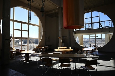 Arcosanti cafe's dining area in the Crafts III building is pictured. It is located two stories below the Arcosanti Visitors' Center and Gallery. Founded in 1970, Arcosanti is a prototype utopian city created by Italian architect Paolo Soleri. This form of ecological urban planning is called “arcology” by Soleri.