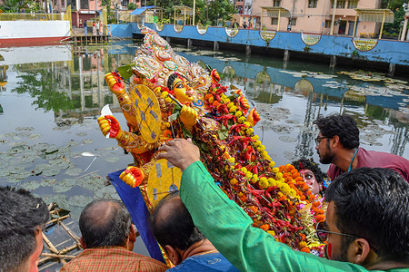 Devotees immerse an idol of the Goddess Durga during the final day “Vijayadashami” marking the end of the Durga Puja festival in Kolkata.