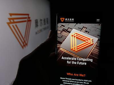 In this photo illustration, a person is holding a smartphone with the webpage of company Moore Threads Technology Co. Ltd. on screen in front of logo.